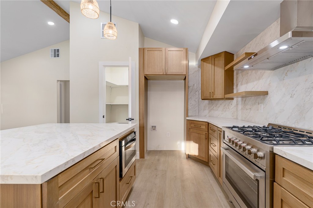 700 West 10th Street Azusa, CA 91702 - Photo 12 of 43 a kitchen with stainless steel appliances granite countertop a sink stove and refrigerator