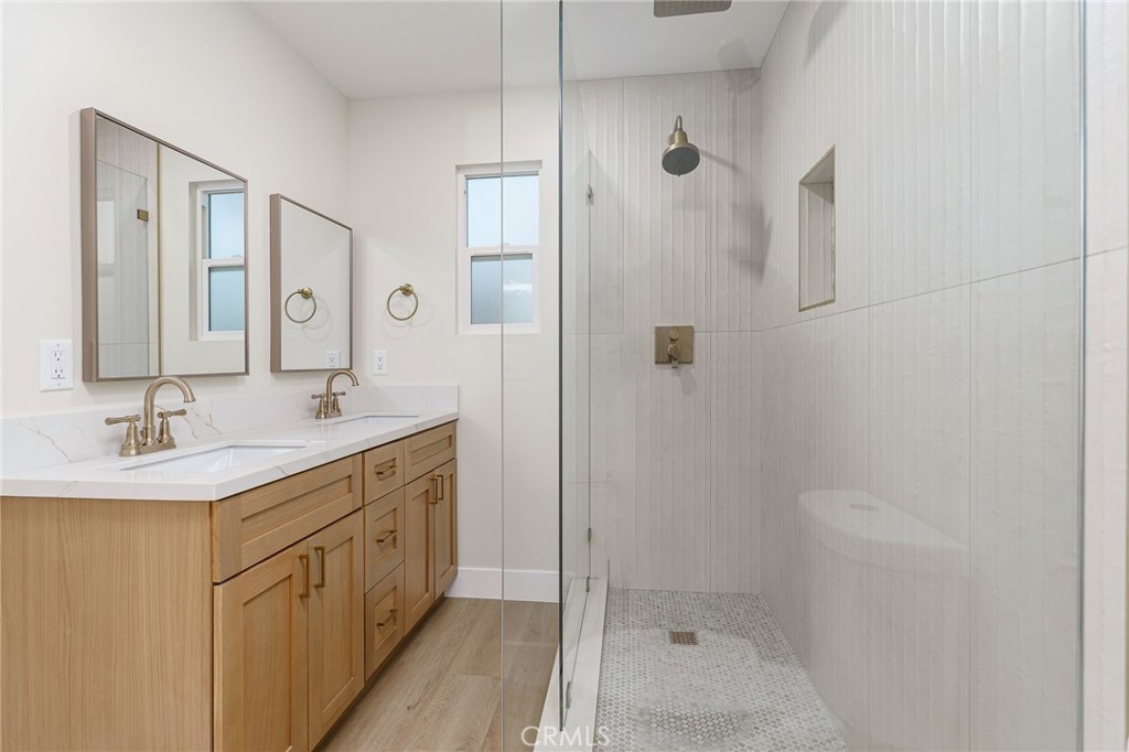 700 West 10th Street Azusa, CA 91702 - Photo 17 of 43 a bathroom with a shower sink and mirror