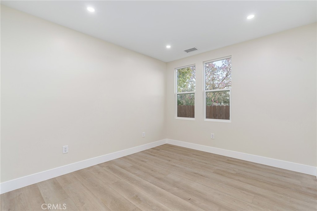 700 West 10th Street Azusa, CA 91702 - Photo 19 of 43 an empty room with wooden floor and windows