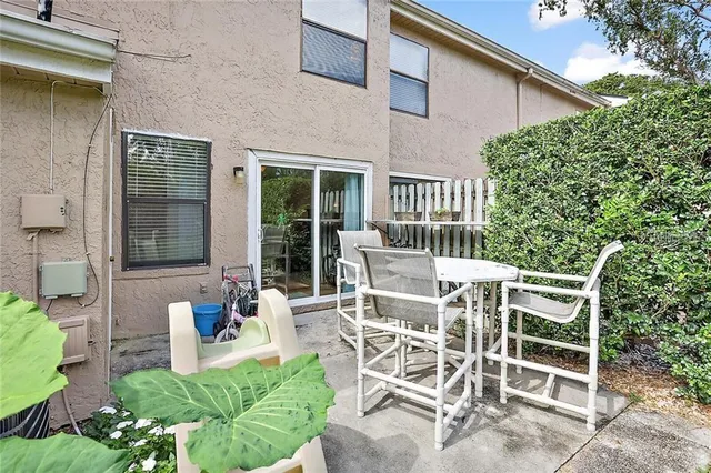 a view of a patio with table and chairs and potted plants