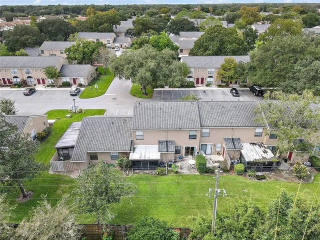 an aerial view of a house with yard swimming pool and outdoor seating