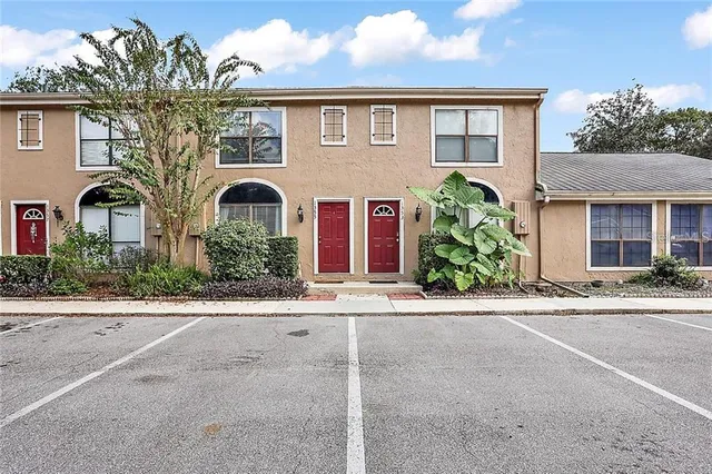 front view of a brick house with a small yard