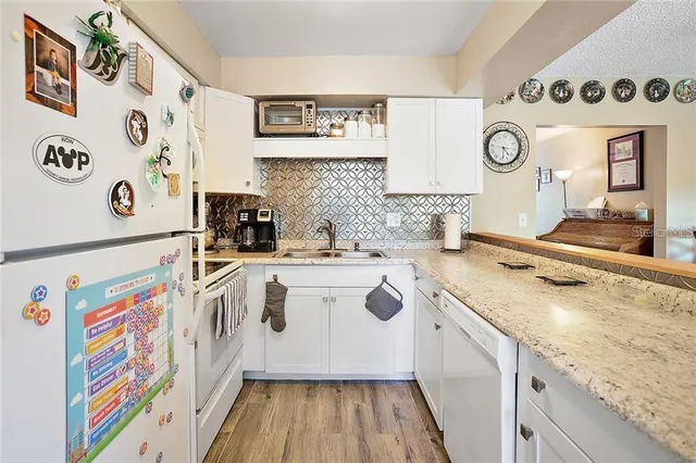 a kitchen with a sink a stove and cabinets