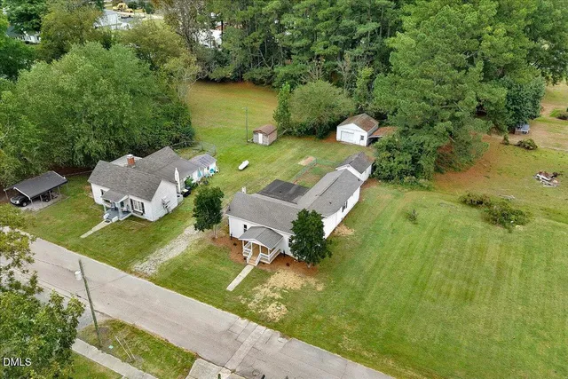 an aerial view of a house with a yard basket ball court and outdoor seating
