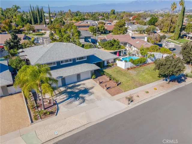 an aerial view of residential houses with outdoor space and street view