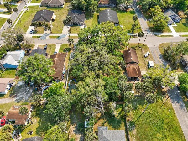 an aerial view of residential house with swimming pool and lawn chairs