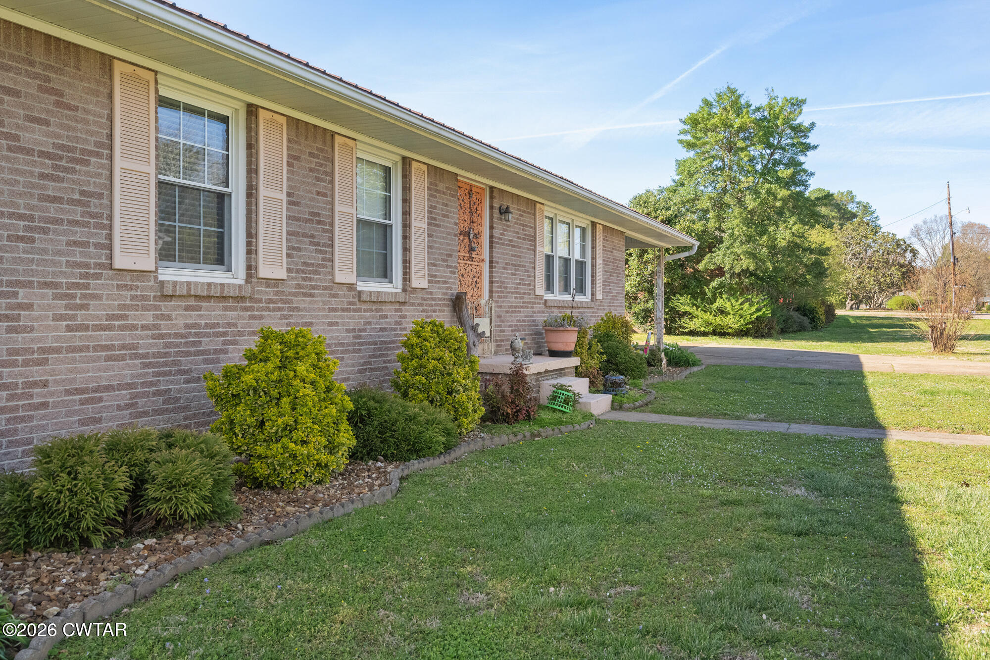 381 Sunset Drive Lexington, TN 38351 - Photo 3 of 26 a front view of a house with a yard