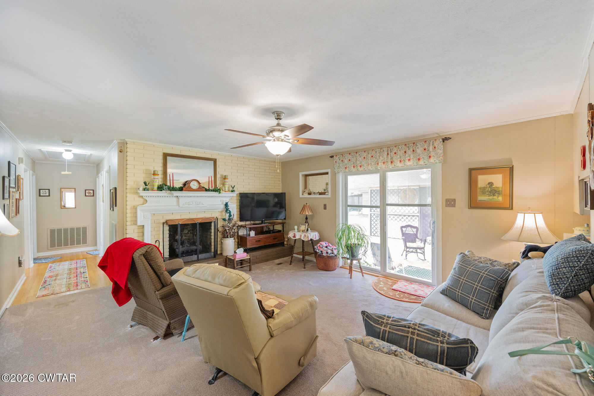 381 Sunset Drive Lexington, TN 38351 - Photo 4 of 26 a living room with furniture a fireplace and a flat screen tv