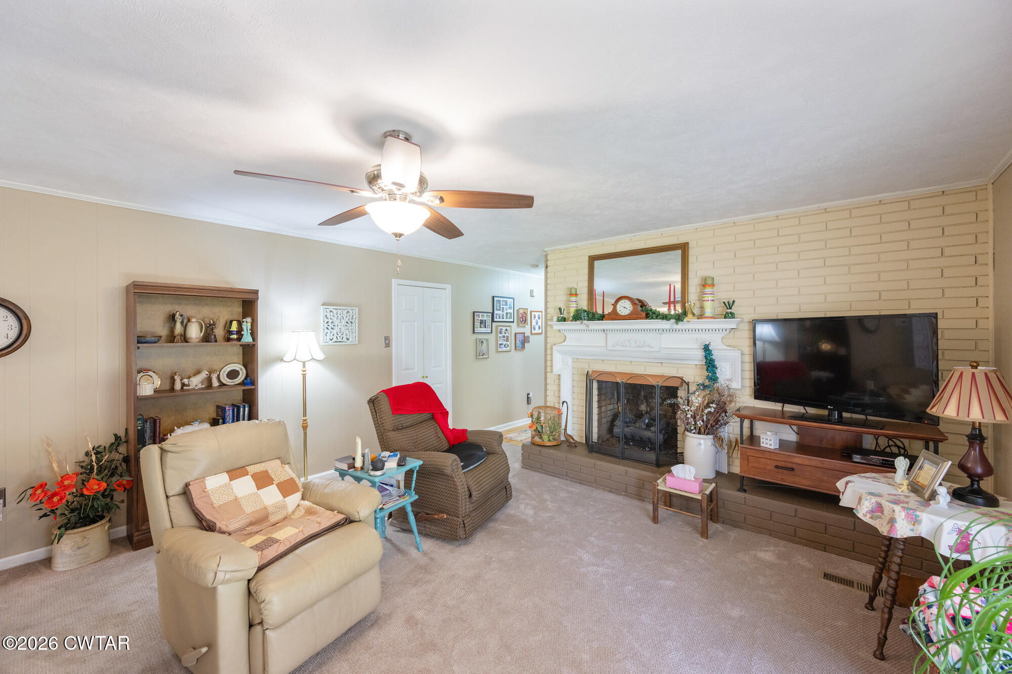 381 Sunset Drive Lexington, TN 38351 - Photo 7 of 26 a living room with furniture a fireplace and a flat screen tv
