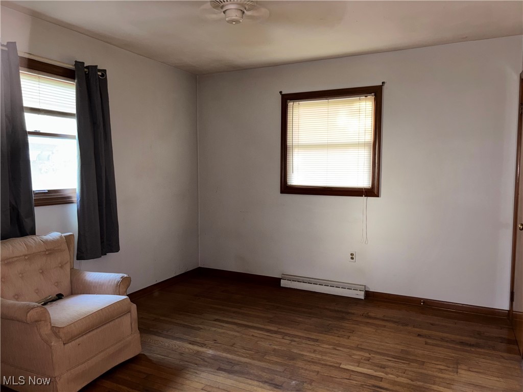 1900 Jaycox Road Avon, OH 44011 - Photo 11 of 26 Unfurnished room featuring dark wood-type flooring and a baseboard heating unit