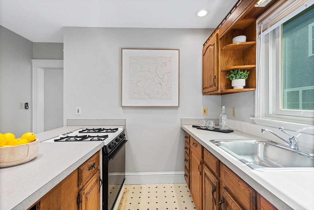 57 Huron Circle Boston, MA 02124 - Photo 14 of 32 a kitchen that has a sink and a stove