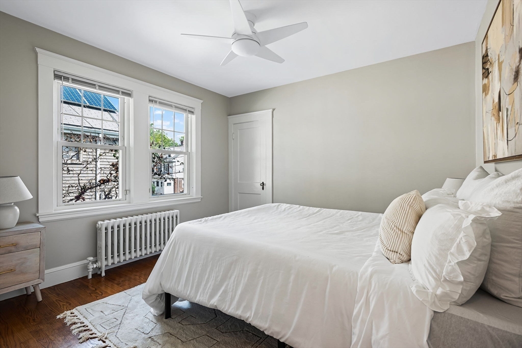 57 Huron Circle Boston, MA 02124 - Photo 15 of 32 a bedroom with a bed and a window with chair