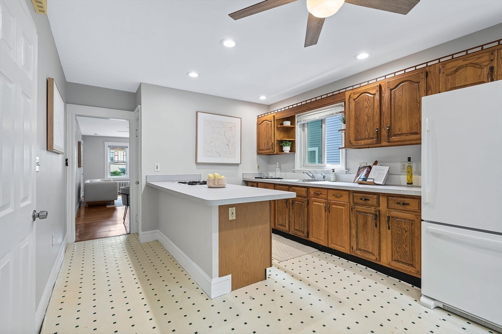 57 Huron Circle Boston, MA 02124 - Photo 21 of 32 a large kitchen with stainless steel appliances kitchen island granite countertop a sink and cabinets