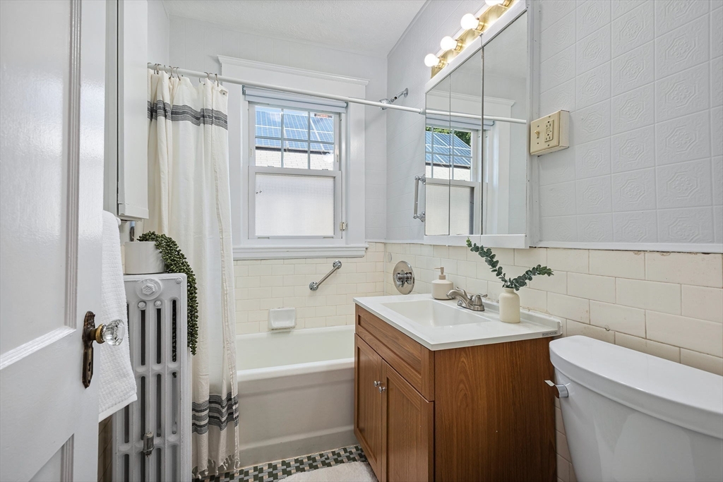 57 Huron Circle Boston, MA 02124 - Photo 22 of 32 a bathroom with a sink and a mirror