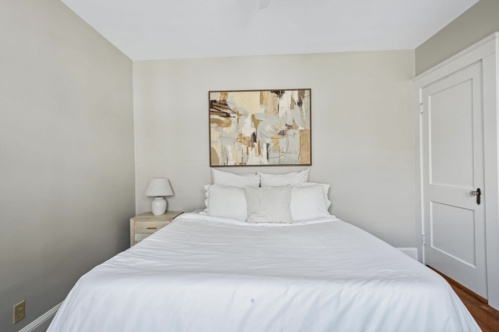57 Huron Circle Boston, MA 02124 - Photo 23 of 32 a bedroom with a bed and painting on the wall