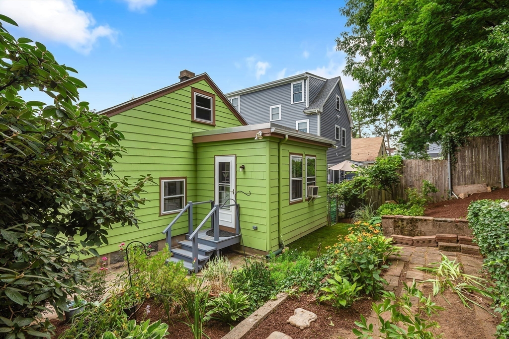 57 Huron Circle Boston, MA 02124 - Photo 27 of 32 a view of a house with a small yard plants and large tree
