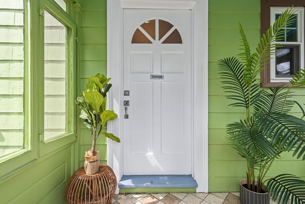 57 Huron Circle Boston, MA 02124 - Photo 3 of 32 a vase of flowers sitting on a floor in front of a door