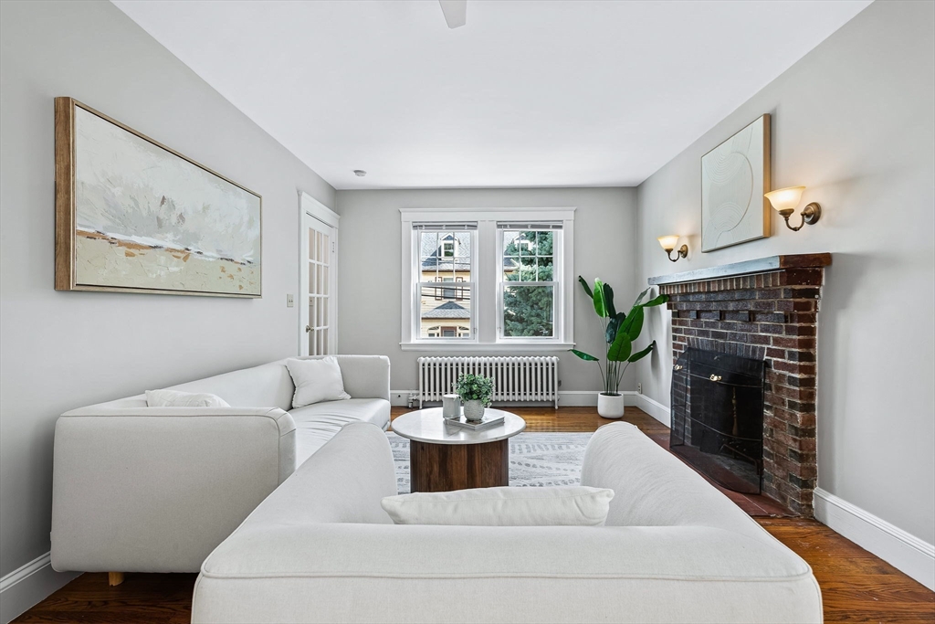57 Huron Circle Boston, MA 02124 - Photo 10 of 32 a living room with furniture a fireplace and a table