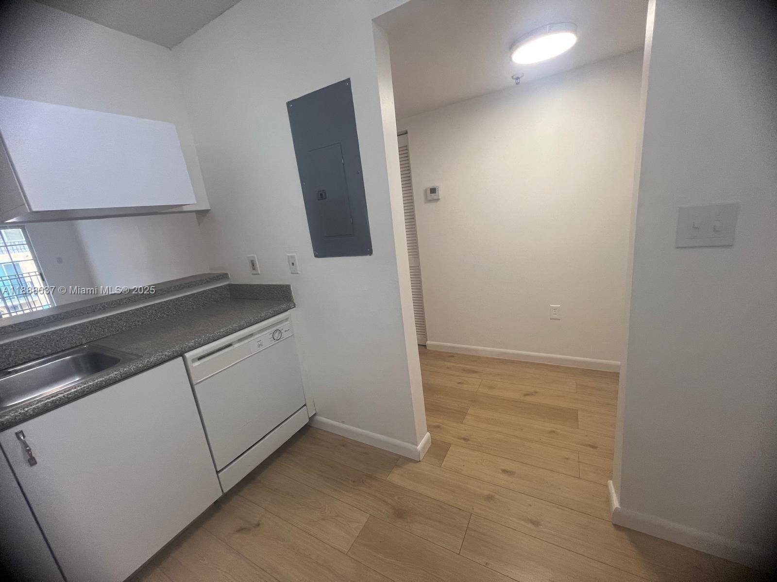 8900 Collins Avenue, Unit 203 Surfside, FL 33154 - Photo 5 of 11 a view of cabinets and wooden floor