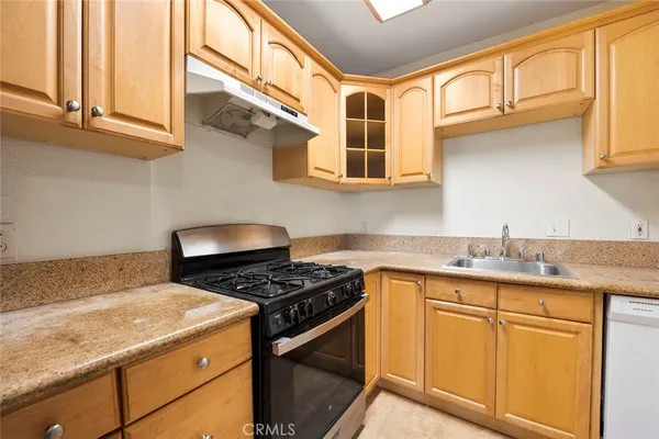 a kitchen with stainless steel appliances granite countertop a stove and a refrigerator