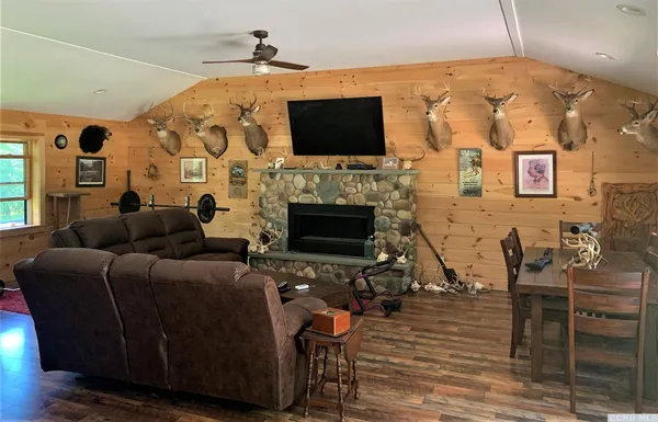 a living room with furniture flat screen tv and a fireplace