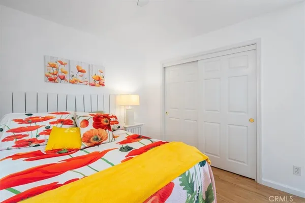 a view of a livingroom with wooden floor and a fireplace