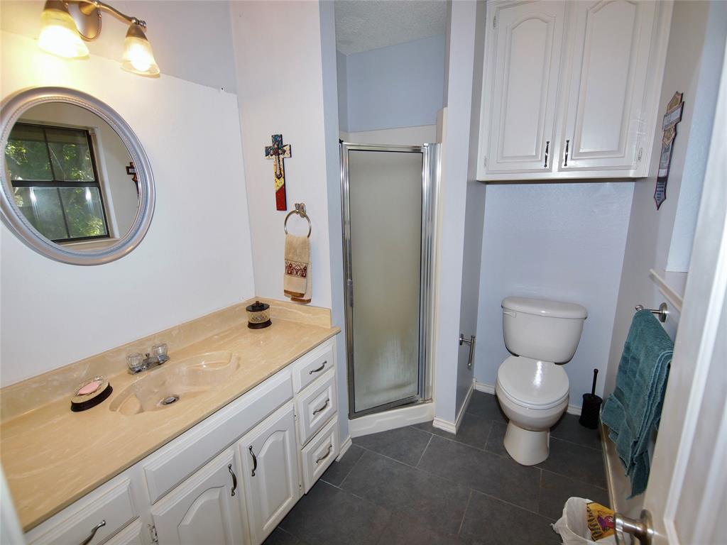 3106 South Lipsey Street Decatur, TX 76234 - Photo 12 of 27 a bathroom with a sink and a toilet