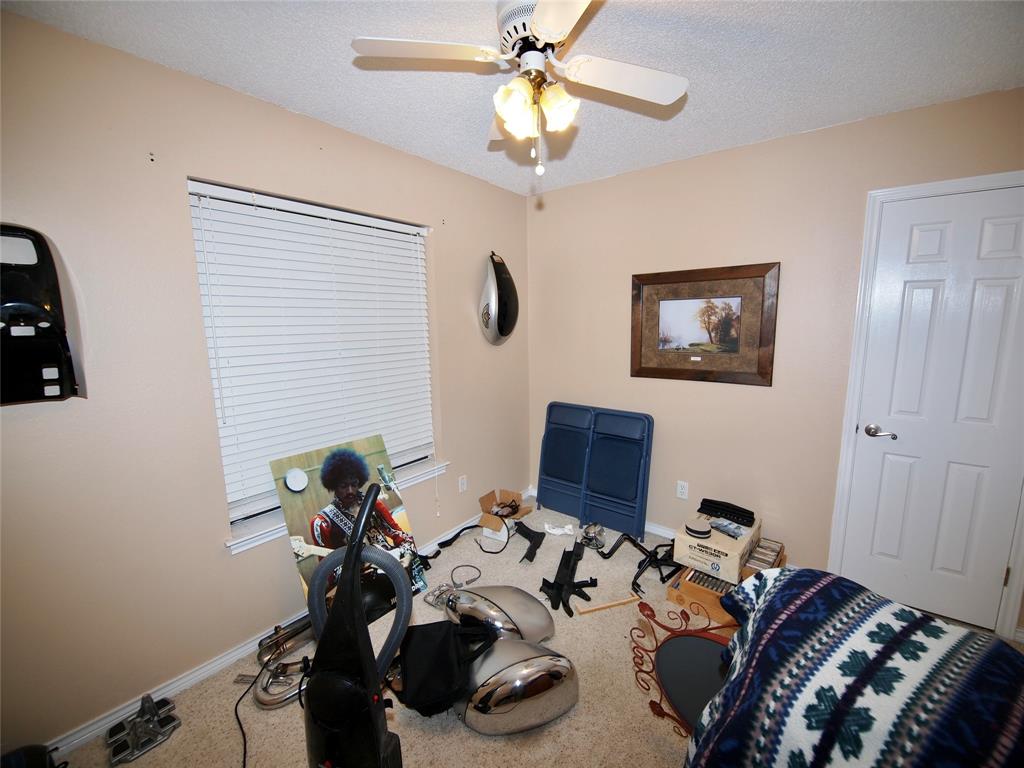 3106 South Lipsey Street Decatur, TX 76234 - Photo 16 of 27 a bedroom with bed a chandelier and a window