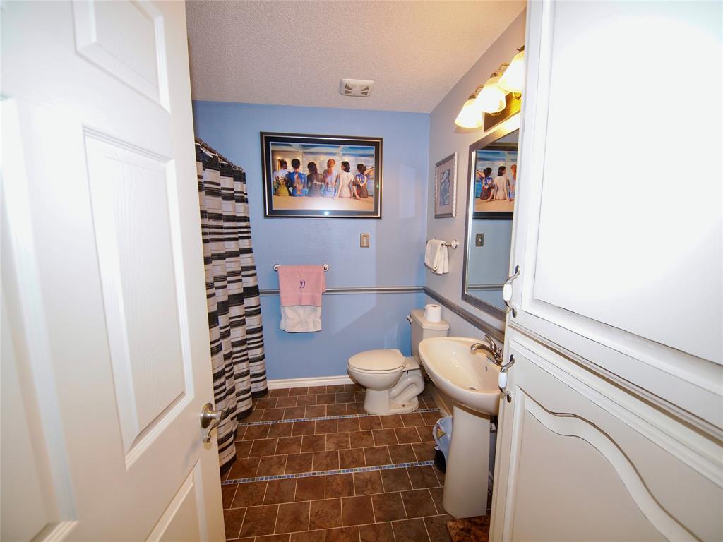 3106 South Lipsey Street Decatur, TX 76234 - Photo 17 of 27 a bathroom with a toilet and a shower
