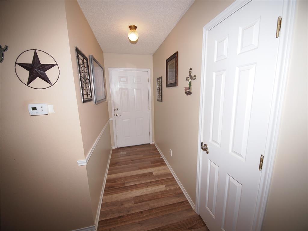 3106 South Lipsey Street Decatur, TX 76234 - Photo 19 of 27 a view of a hallway with wooden floor and entryway