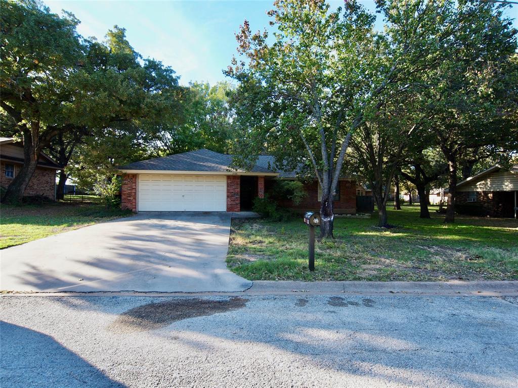 3106 South Lipsey Street Decatur, TX 76234 - Photo 27 of 27 a front view of a house with a yard and a garden