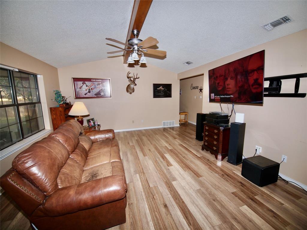 3106 South Lipsey Street Decatur, TX 76234 - Photo 3 of 27 a living room with furniture and a flat screen tv