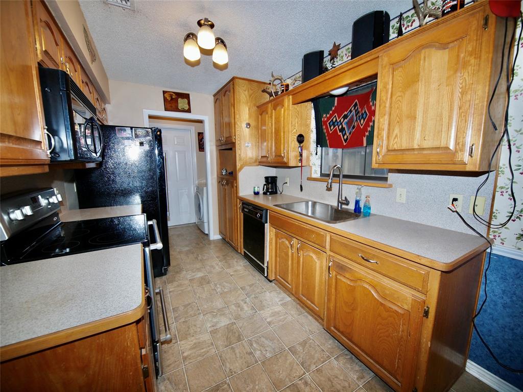 3106 South Lipsey Street Decatur, TX 76234 - Photo 7 of 27 a kitchen with stainless steel appliances a sink stove and refrigerator