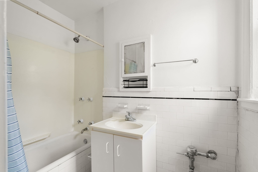 97 Chester Street, Unit 8 Boston, MA 02134 - Photo 17 of 19 a bathroom with a sink and a mirror