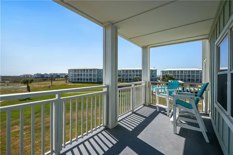 a view of a balcony with chairs