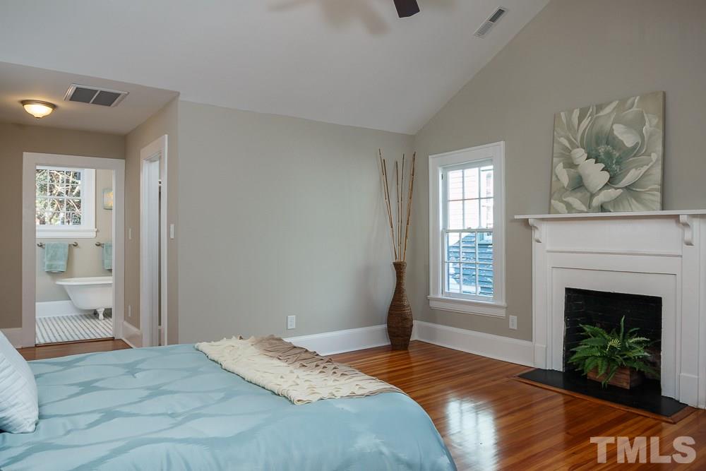 605 North East Street Raleigh, NC 27604 - Photo 13 of 25 a bedroom with a bed and a fireplace