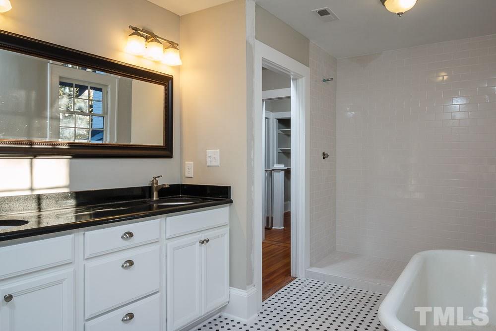 605 North East Street Raleigh, NC 27604 - Photo 17 of 25 a bathroom with a granite countertop sink a mirror and a shower