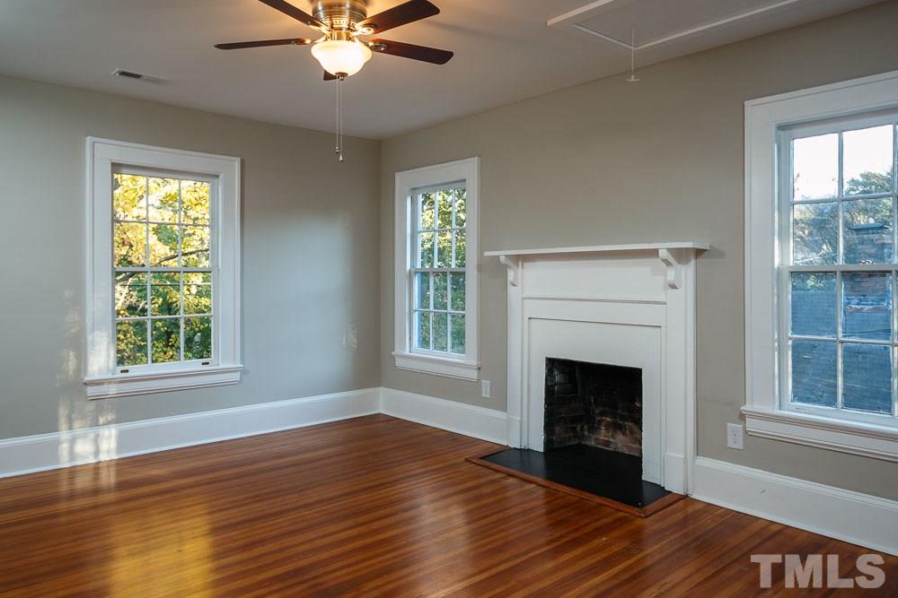 605 North East Street Raleigh, NC 27604 - Photo 18 of 25 a view of an empty room with wooden floor fireplace and a window