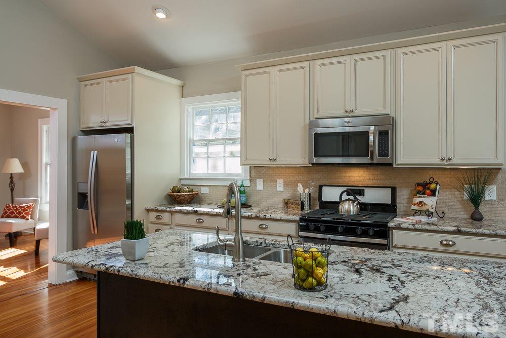 605 North East Street Raleigh, NC 27604 - Photo 7 of 25 a kitchen with a sink a stove and cabinets