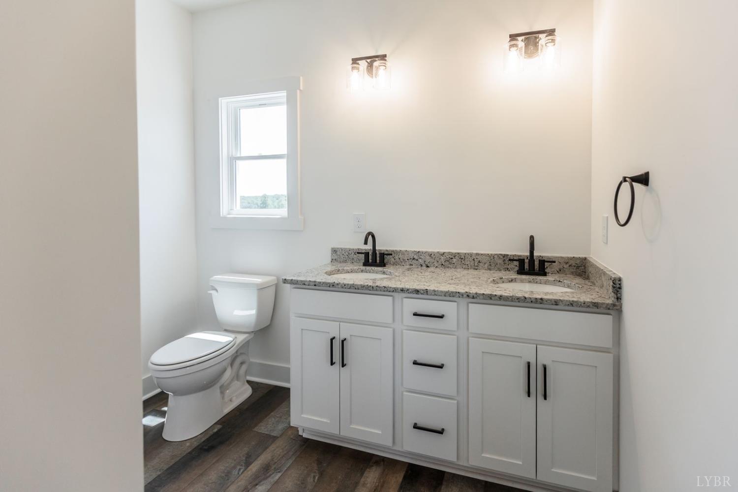 9740 Oakville Road Gladstone, VA 24553 - Photo 44 of 75 a bathroom with a granite countertop toilet sink and mirror