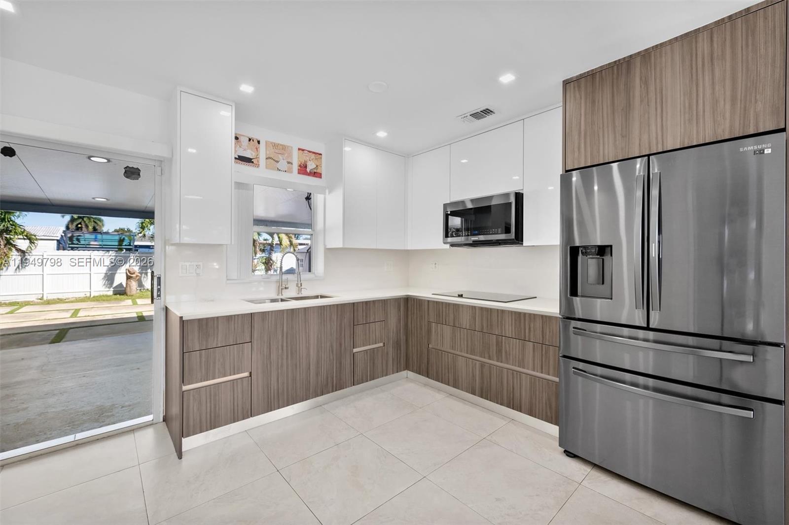 6231 Mayo Street Hollywood, FL 33023 - Photo 8 of 34 a kitchen with a refrigerator and a sink