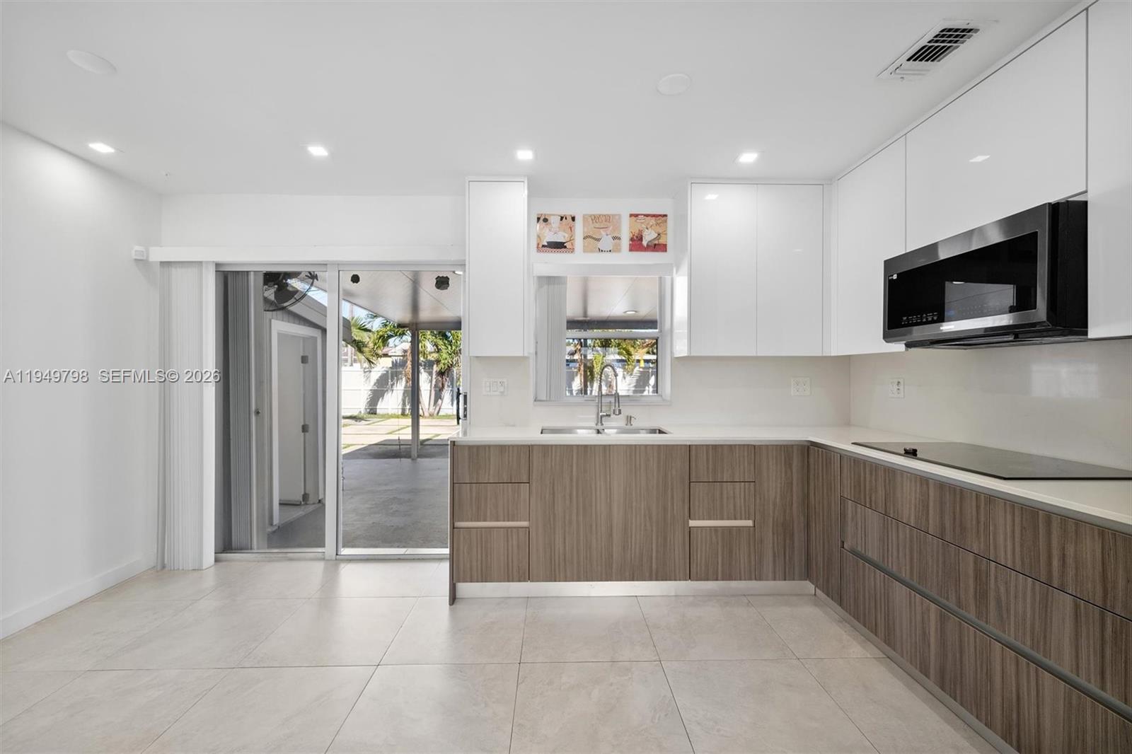 6231 Mayo Street Hollywood, FL 33023 - Photo 9 of 34 a view of kitchen with stainless steel appliances granite countertop a refrigerator and a sink
