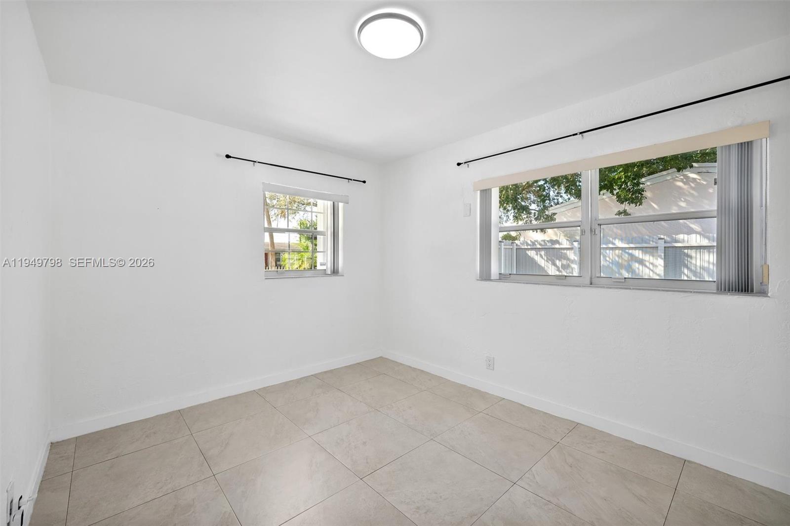6231 Mayo Street Hollywood, FL 33023 - Photo 10 of 34 an empty room with windows