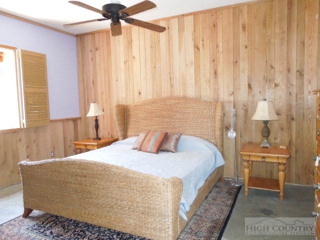 3086 Summit Road Purlear, NC 28665 - Photo 9 of 13 a bedroom with a bed and a chandelier