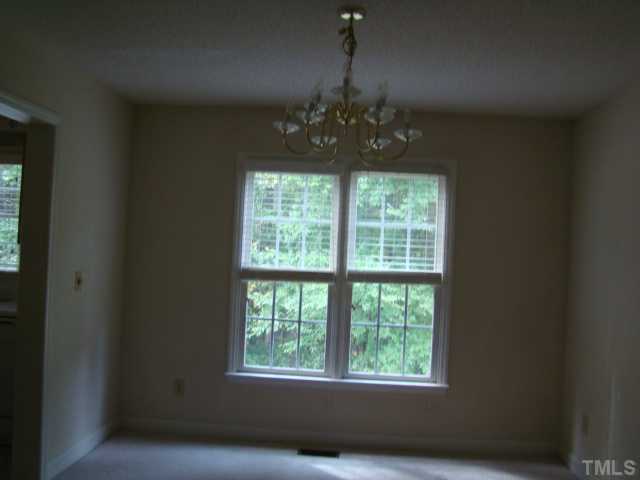 6012 Eaglesfield Drive Raleigh, NC 27613 - Photo 5 of 9 a view of a windows and an chandelier in a room