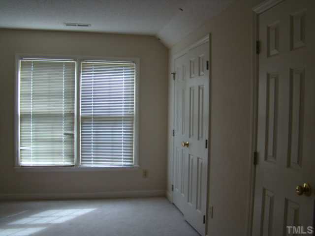 6012 Eaglesfield Drive Raleigh, NC 27613 - Photo 7 of 9 a view of empty room with windows