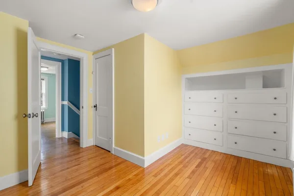 a view of a room with wooden floor