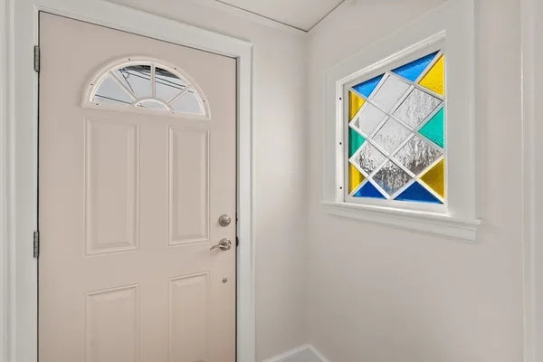 a view of front door with a hallway