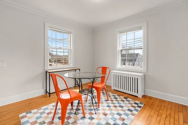 a view of a dining room with furniture and wooden floor