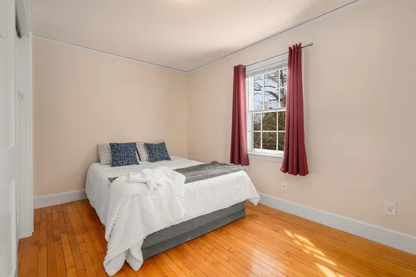 a bed sitting in a bedroom next to a window